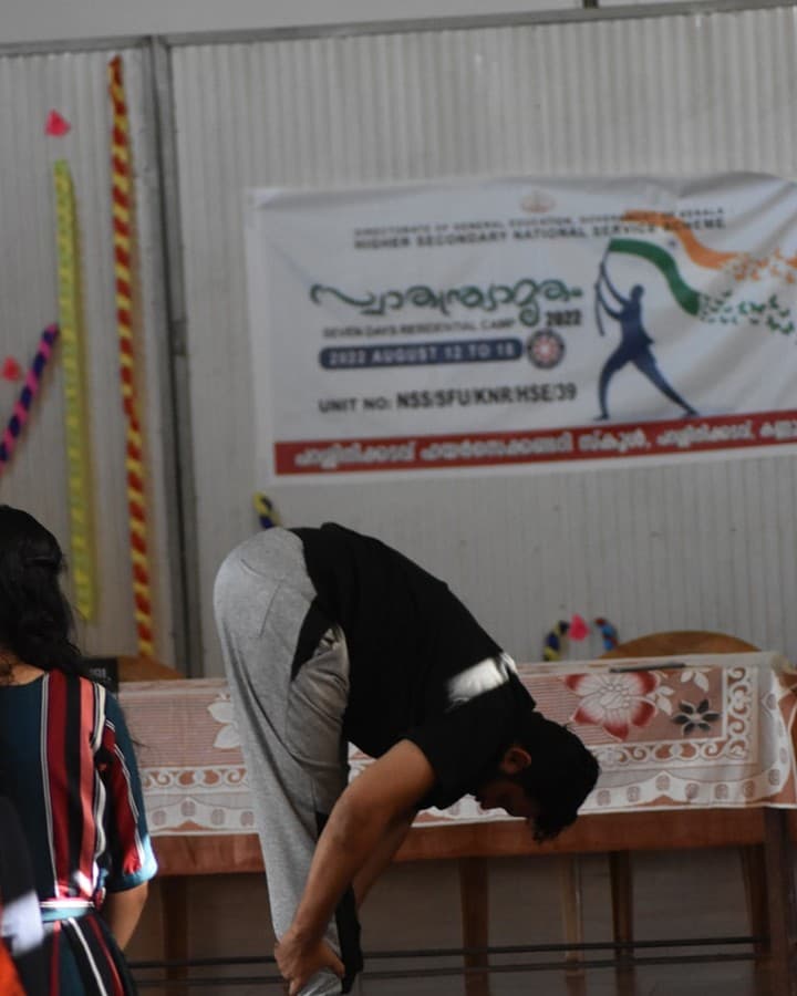 Workshop facilitator demonstrating a forward fold