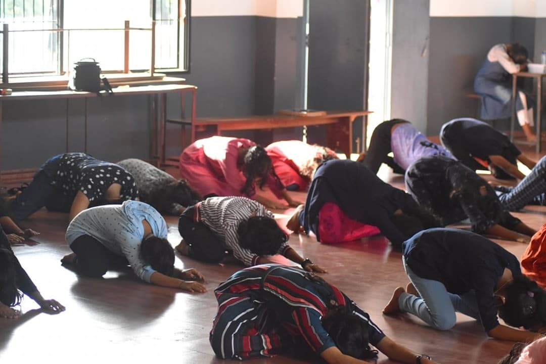 Students practising a resting pose together