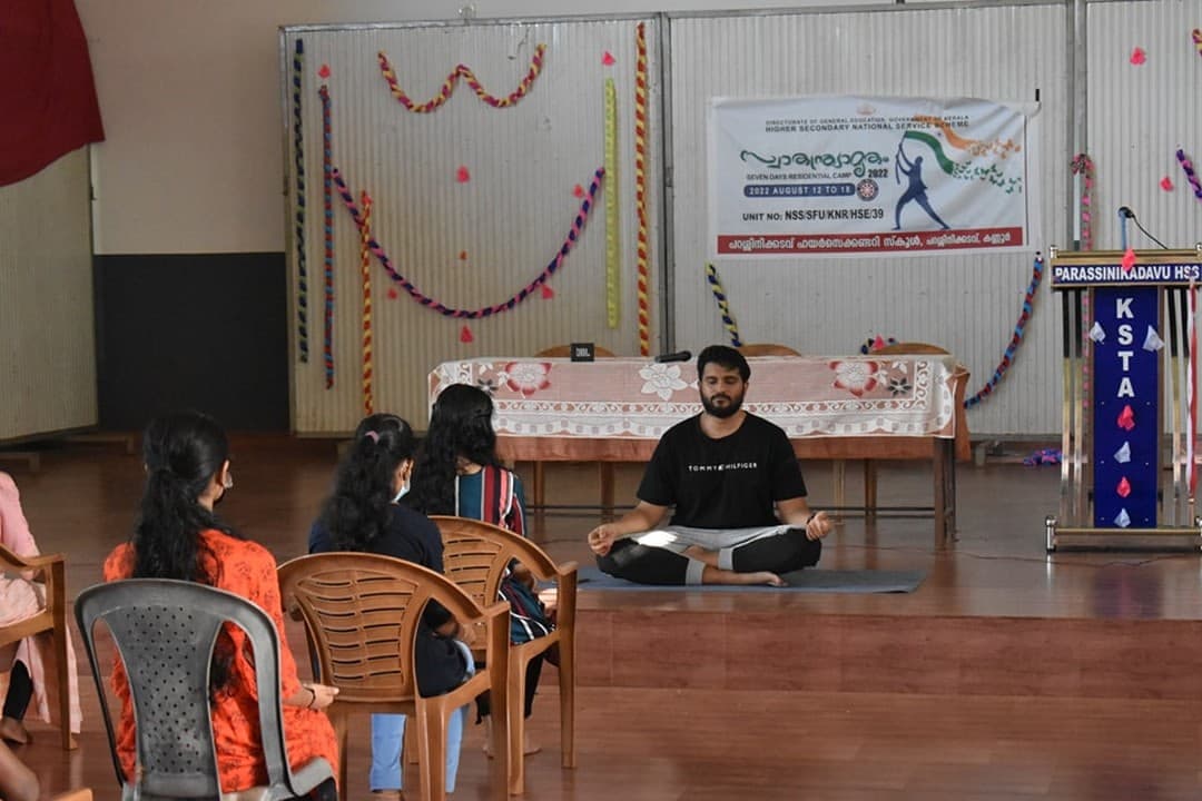 A seated meditation demonstration during a school workshop