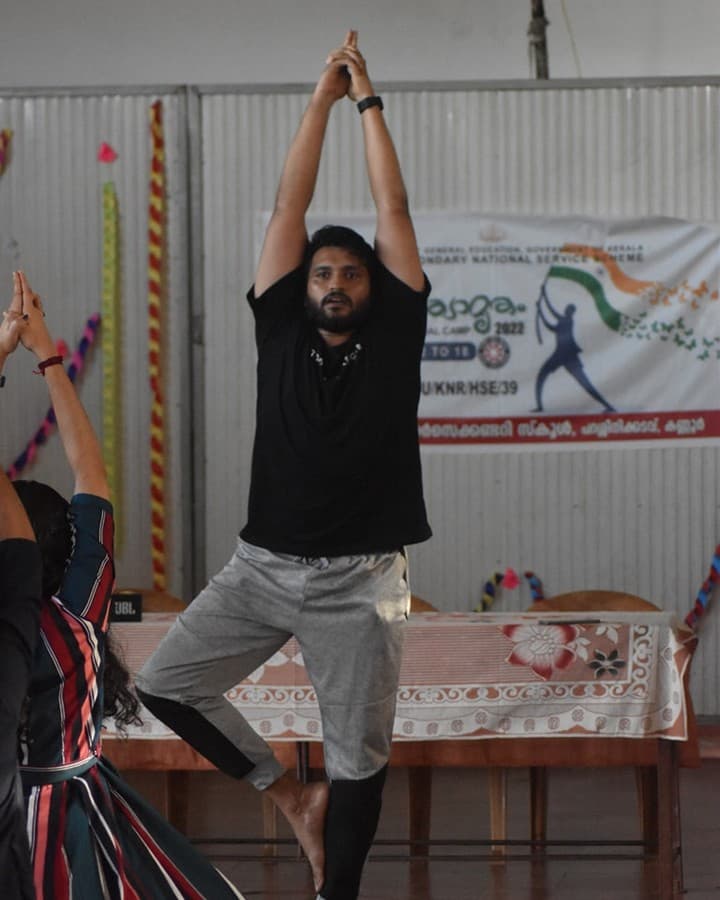 Workshop facilitator demonstrating a standing balance pose
